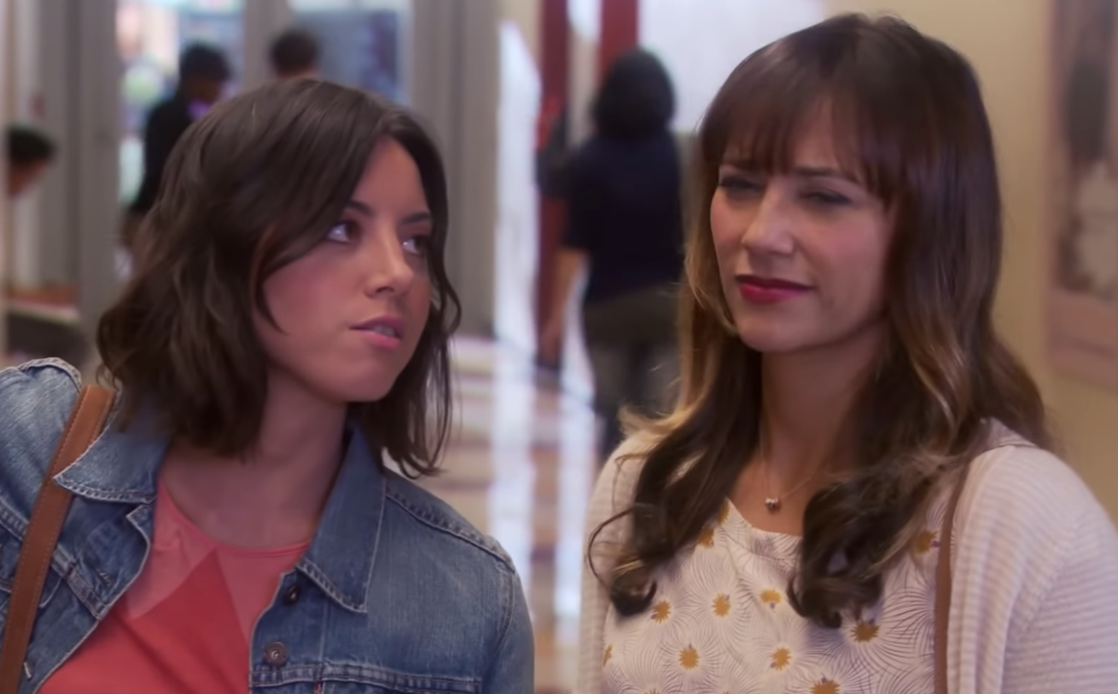 April Ludgate leans in to talk closely with Ann Perkins, who looks visibly annoyed