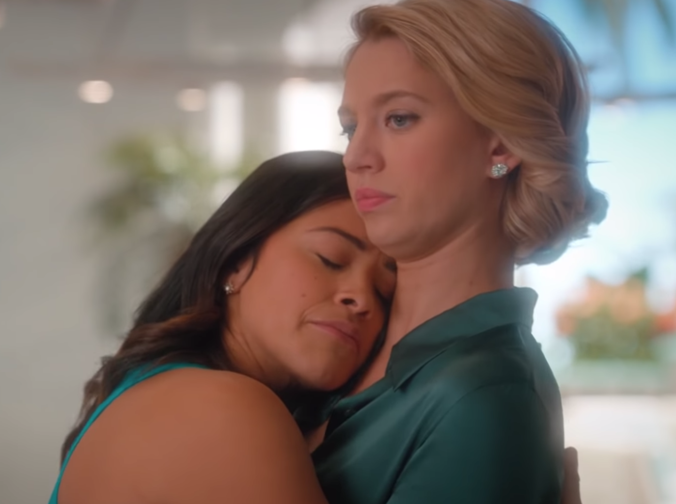 Jane Villanueva hugs Petra Solano tightly as Petra pretends to look annoyed about it
