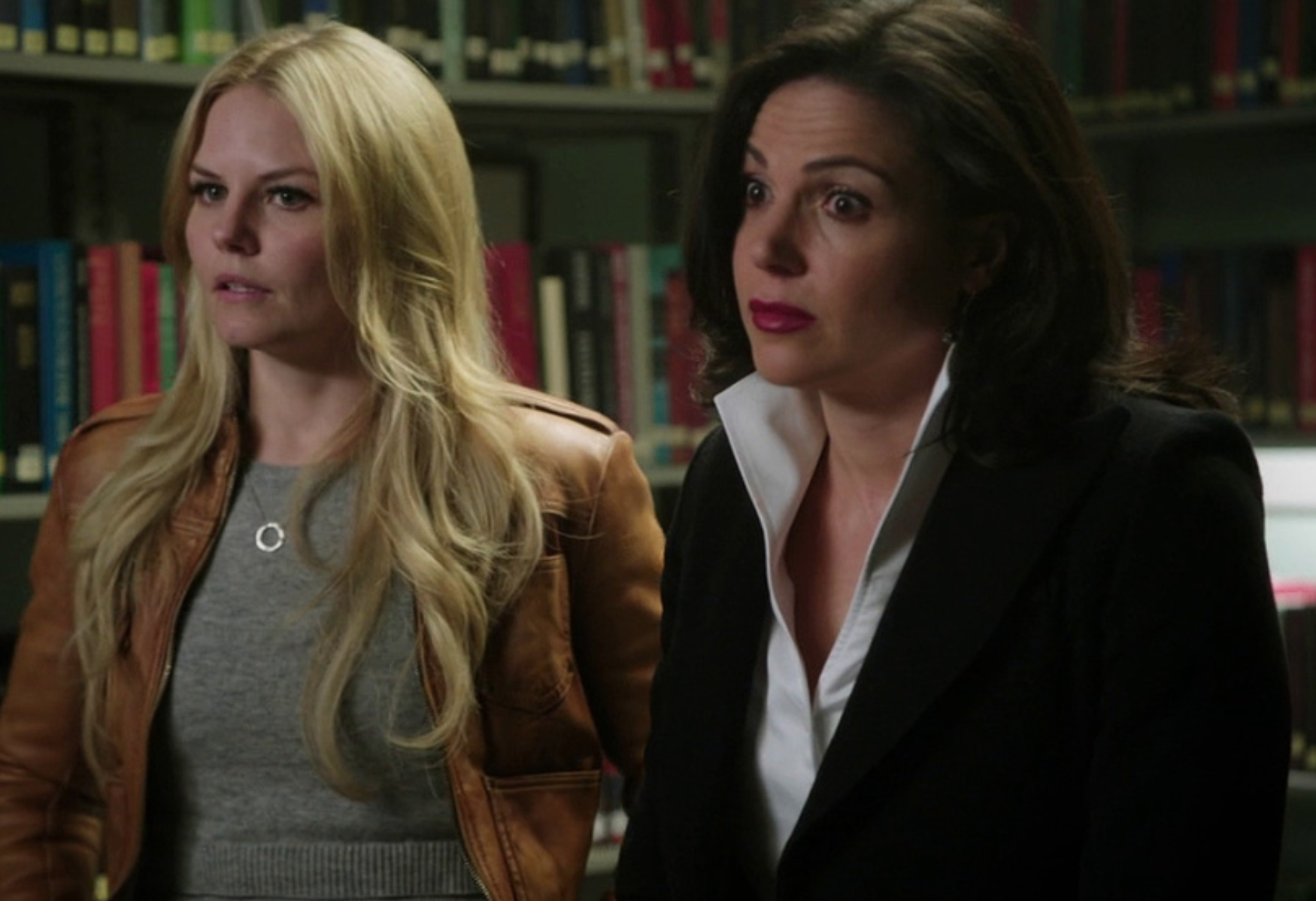 Emma Swan stands with her hands on her hips, and Regina Mills has both eyebrows arched in shock
