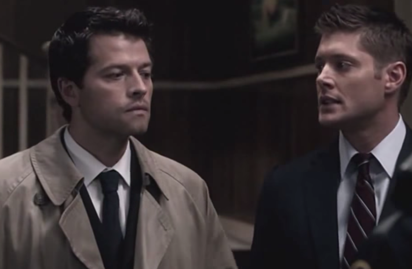 Dean Winchester looks exasperated at Castiel, who stands with a blank look on his face
