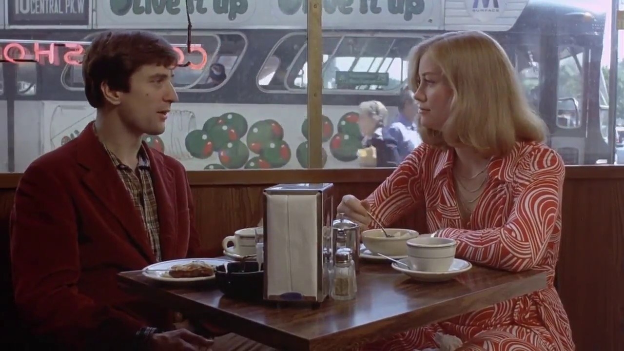 Travis and Iris sitting down for a meal in "Taxi Driver"