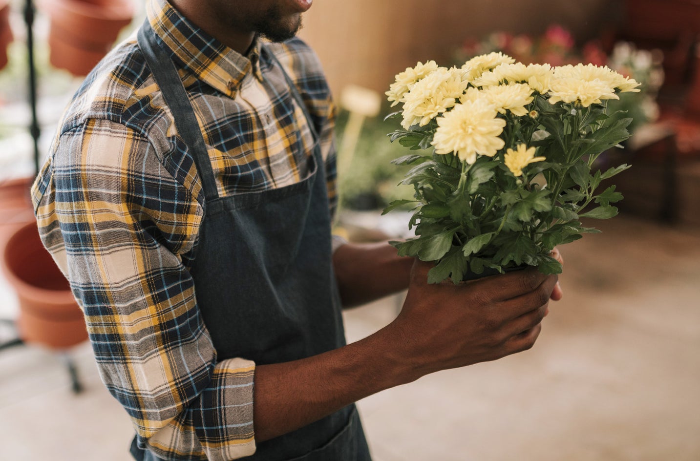 A florist holds a bouquet of fresh flowers