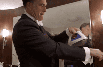 Mitt Romney ironing his suit while it&#x27;s on his body