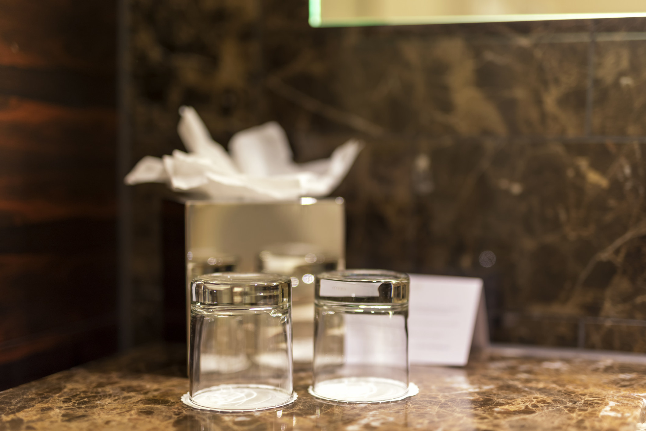 Some clean-looking glass cups in a hotel room