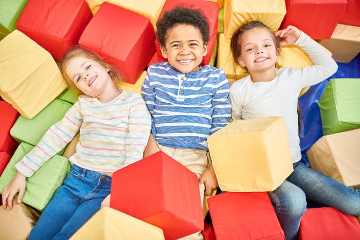 Kids happily play in a foam pit