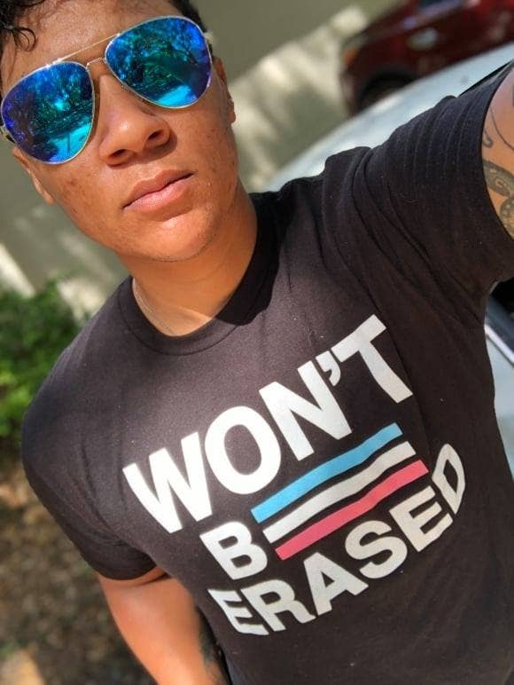 Wells wears a shirt that reads "Won't Be Erased"