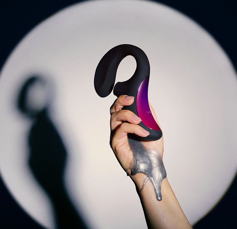 a model's hand holds up the black Enigma as silver ooze drips down their hand