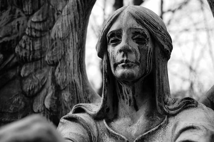 the angel with black tears falling down her sculpted face