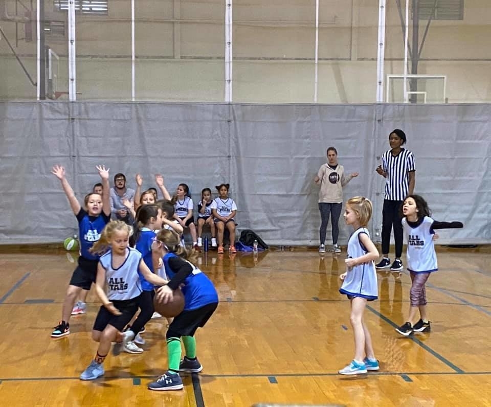 A team of young girls playing basketball