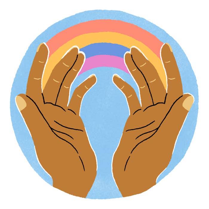 Open palms with a rainbow traversing them
