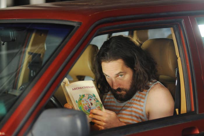 Paul Rudd reading in a car and spying on someone