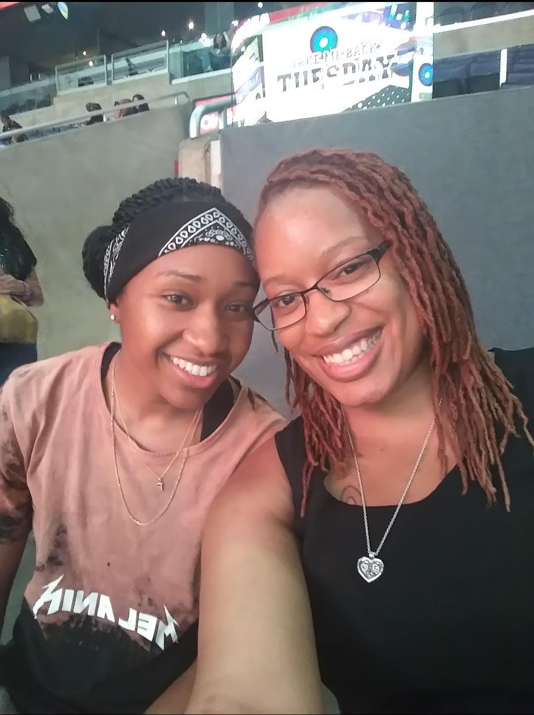 Precious and her wife taking a selfie at a stadium