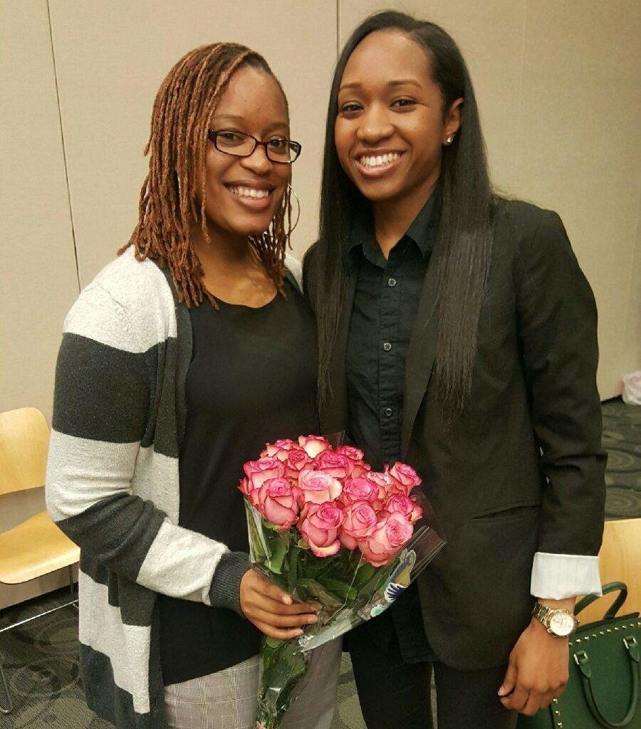 Precious and her wife holding flowers