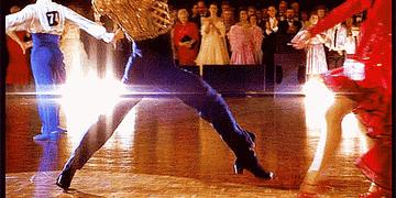 Scott Hastings in Strictly Ballroom on the dance floor, squatting down into a pose.