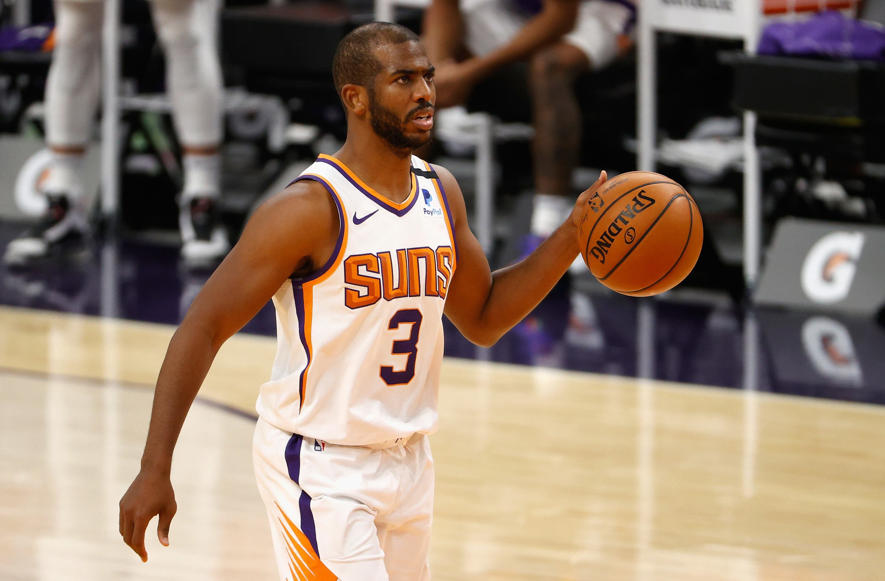 White Suns jersey with orange lettering and purple numbers