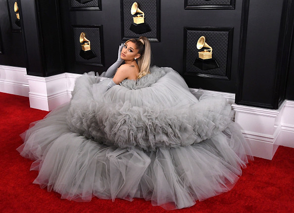 Ariana posing in a layered, tulle gown and matching gloves
