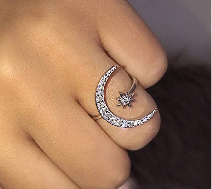 Hand with a moon and star ring on the ring finger