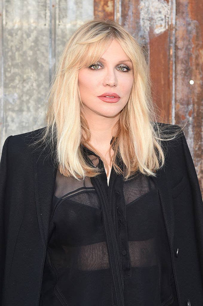 Courtney wearing a black transparent top and jacket