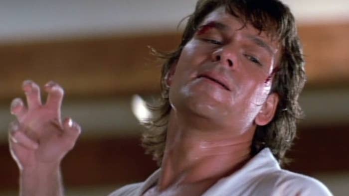 patrick swayze with hand in claw-shape, dancing