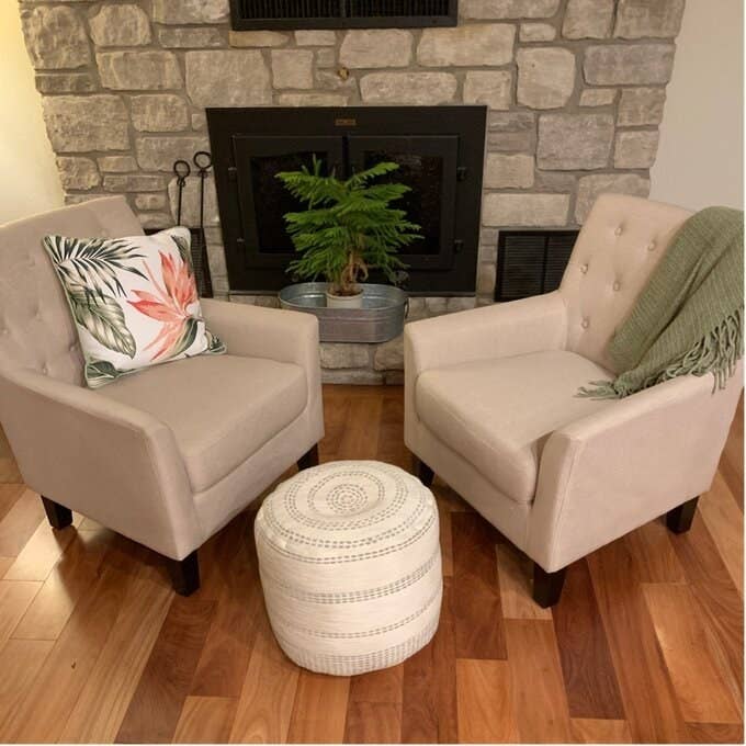 reviewer photo of two of the tufted chairs in oatmeal color