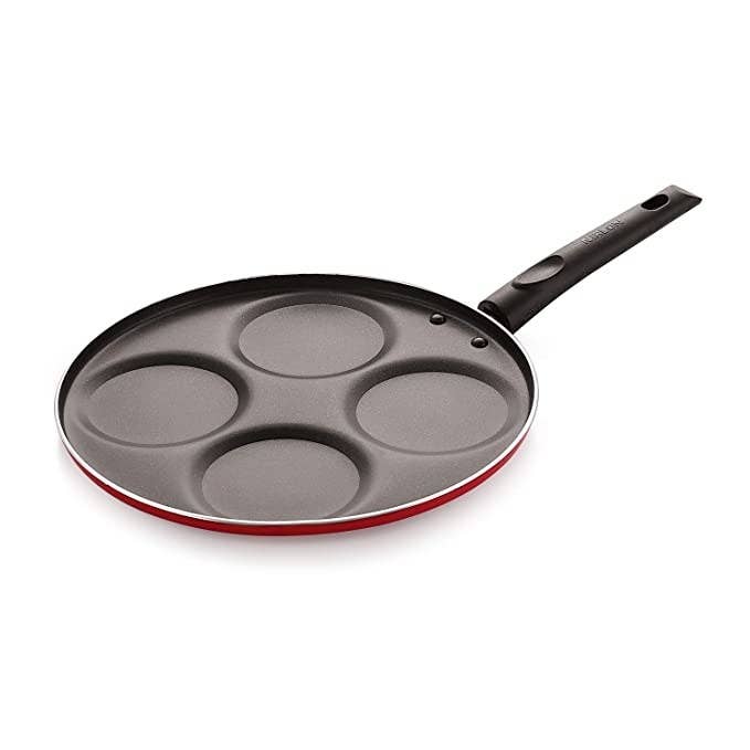 A flat pan with four circular moulds, perfect for pancakes.
