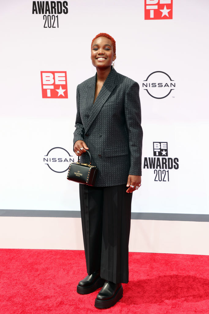 Arlo Parks attends the BET Awards 2021 in a pantsuit and small Valentino purse