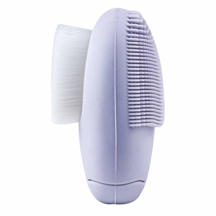 This purple facial massager has silicone brush on one side and a soft sponge on the other.