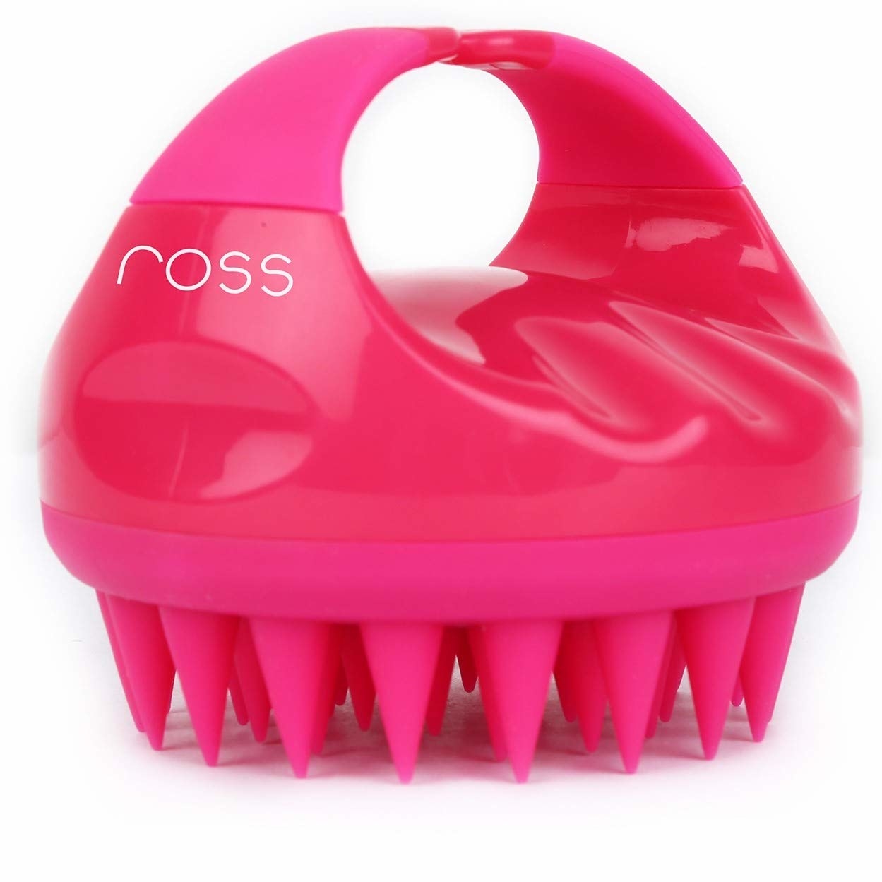 A pink scalp massager with large silicone bristles at the bottom and a handle for ease of use.