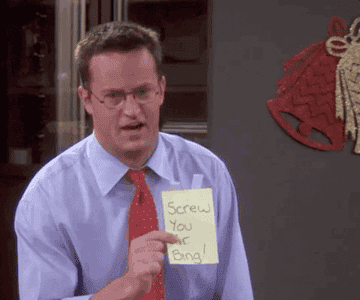 A gif of Chandler holding a post-it that says, &quot;Screw You Mr Bing!&quot; in Friends
