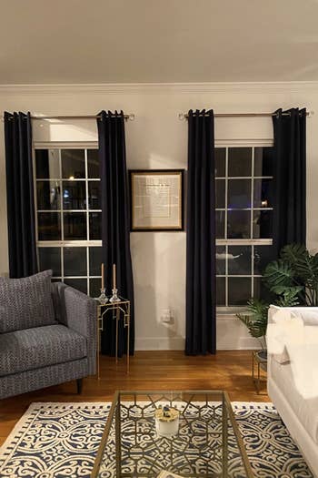 Reviewer's curtain rods are used to cover up two windows in a living room