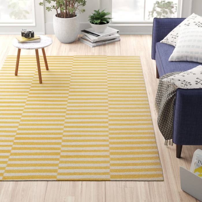 the striped rug in yellow on a living room floor