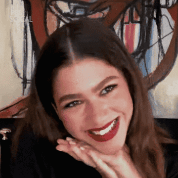 Zendaya smiles in this PBS Zoom interview gif