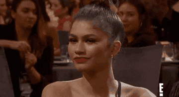 Zendaya smiles in the crowd at an award show in this gif from E!