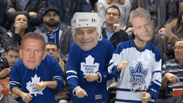 A GIF of people wearing Toronto Maple Leafs jerseys dancing with large cut outs of heads on top of their faces.