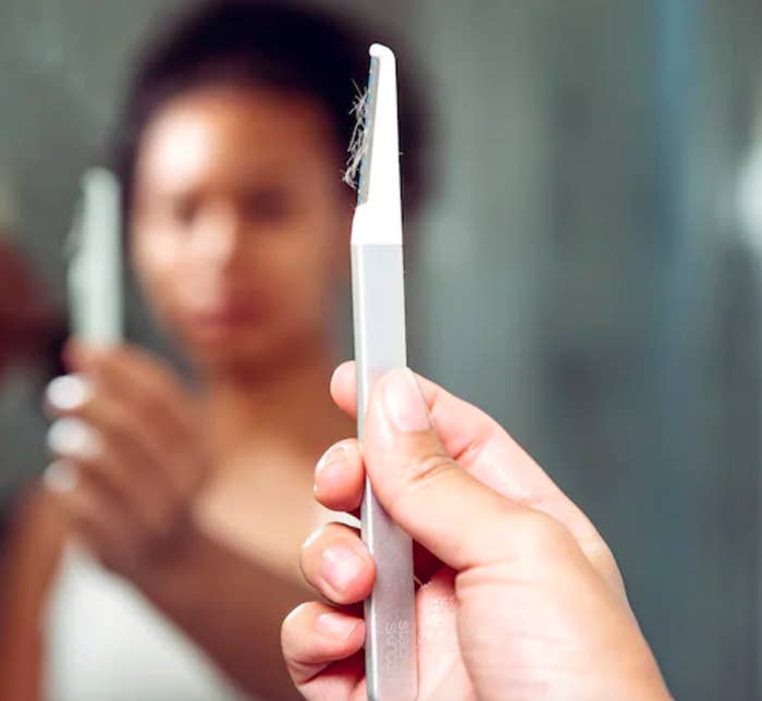 Person holding tool with baby hairs on it after use