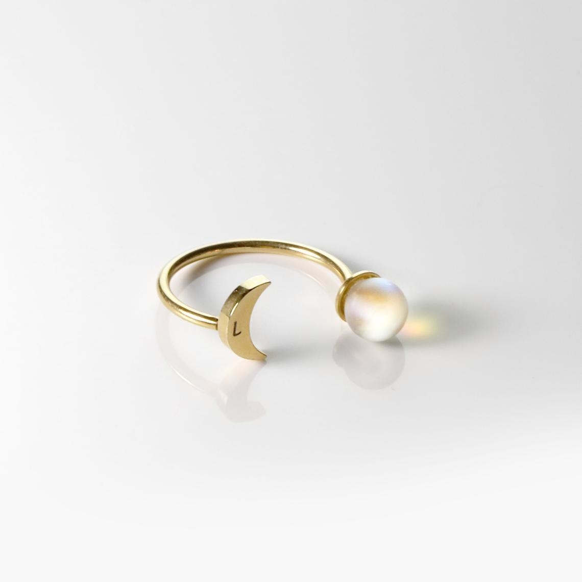 adjustable ring with gold colored crescent moon with single initial on one side and moonstone on the other