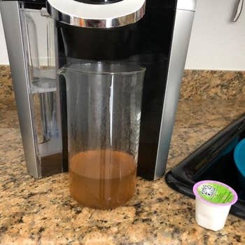 Reviewer's picture of their Keurig machine being cleaned by the cleaning cup 