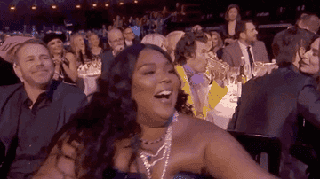 Lizzo stands up and cheers &quot;I love you&quot; while attending the BRIT Awards