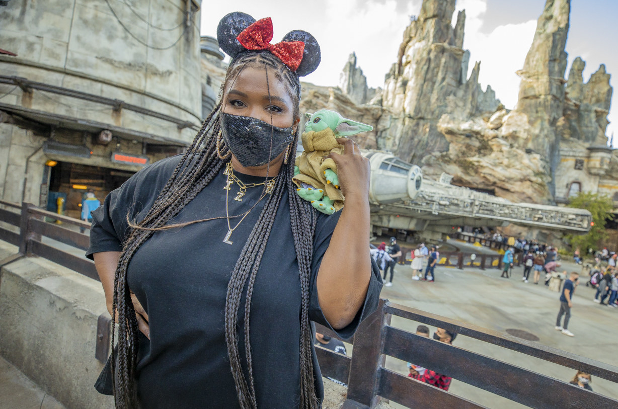 In this handout photo provided by Disneyland Resort, Grammy Award-winning recording artist Lizzo, poses with Baby Yoda in front of the Millennium Falcon in Star Wars: Galaxy&#x27;s Edge at Disneyland Park on May 21, 2021 in Anaheim, California