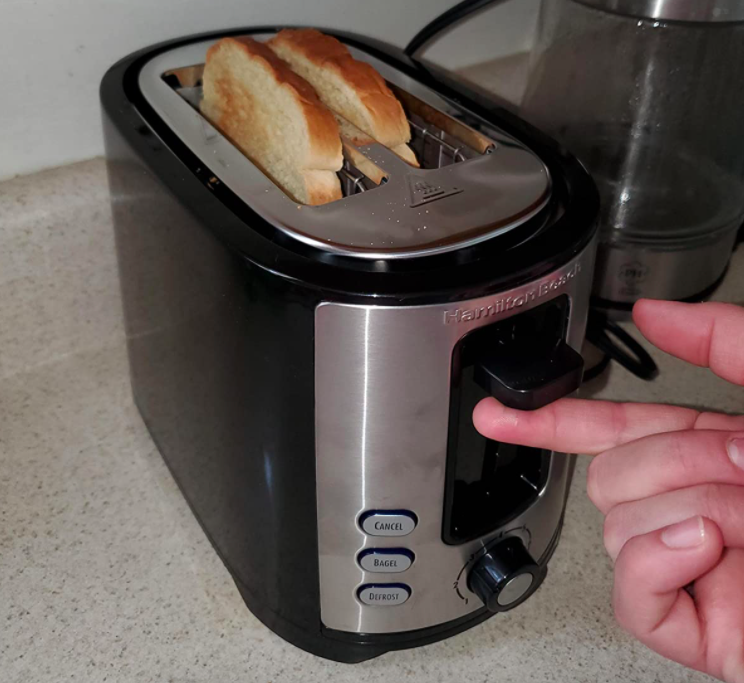 A customer review photo of the toaster on their counter with toast inside