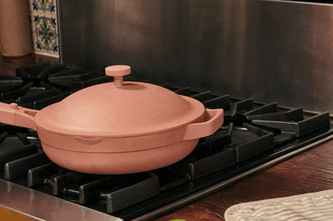 GIF of a hand opening an always pan and removing a steam basket full of dumplings