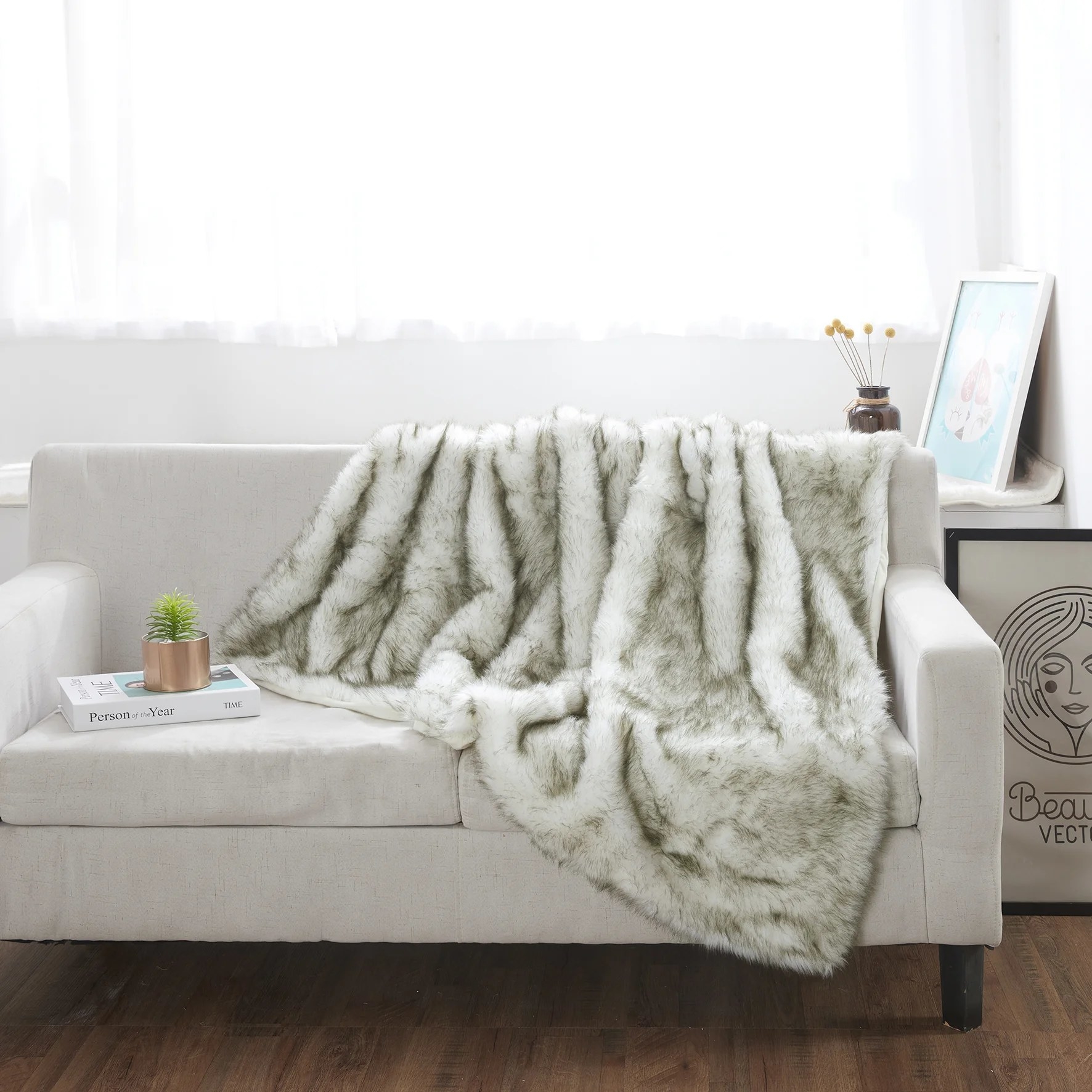 The ivory throw with some dark contrast throughout on the back of a couch