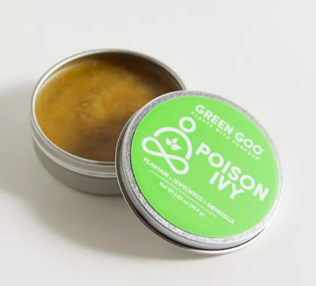 An open tin of poison ivy balm