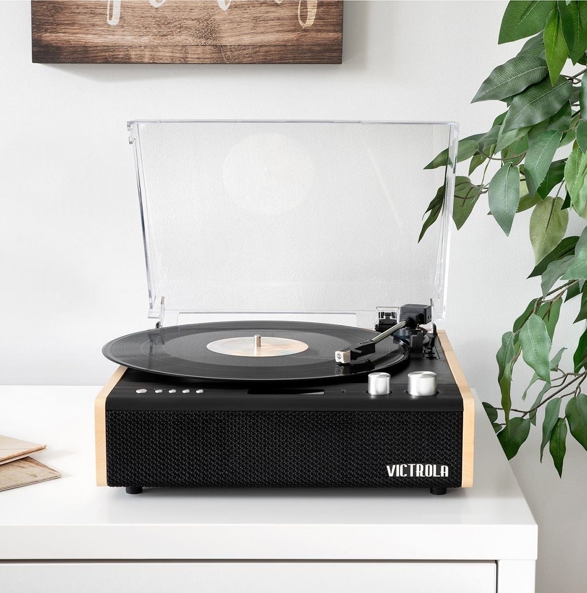 the Victrola eastwood record player open, with a record in it