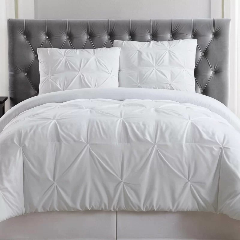 The pleated white duvet and matching pillow cases on a queen bed