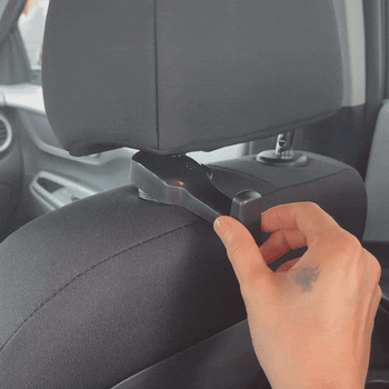 A person moving the hook inside between the headrest legs