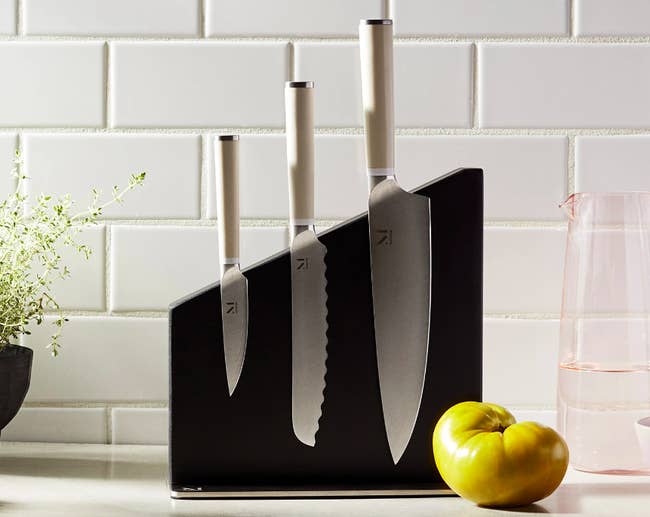 Three knives magnetically held on the side of an angled block