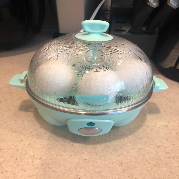 the egg cooker with eggs inside boiling