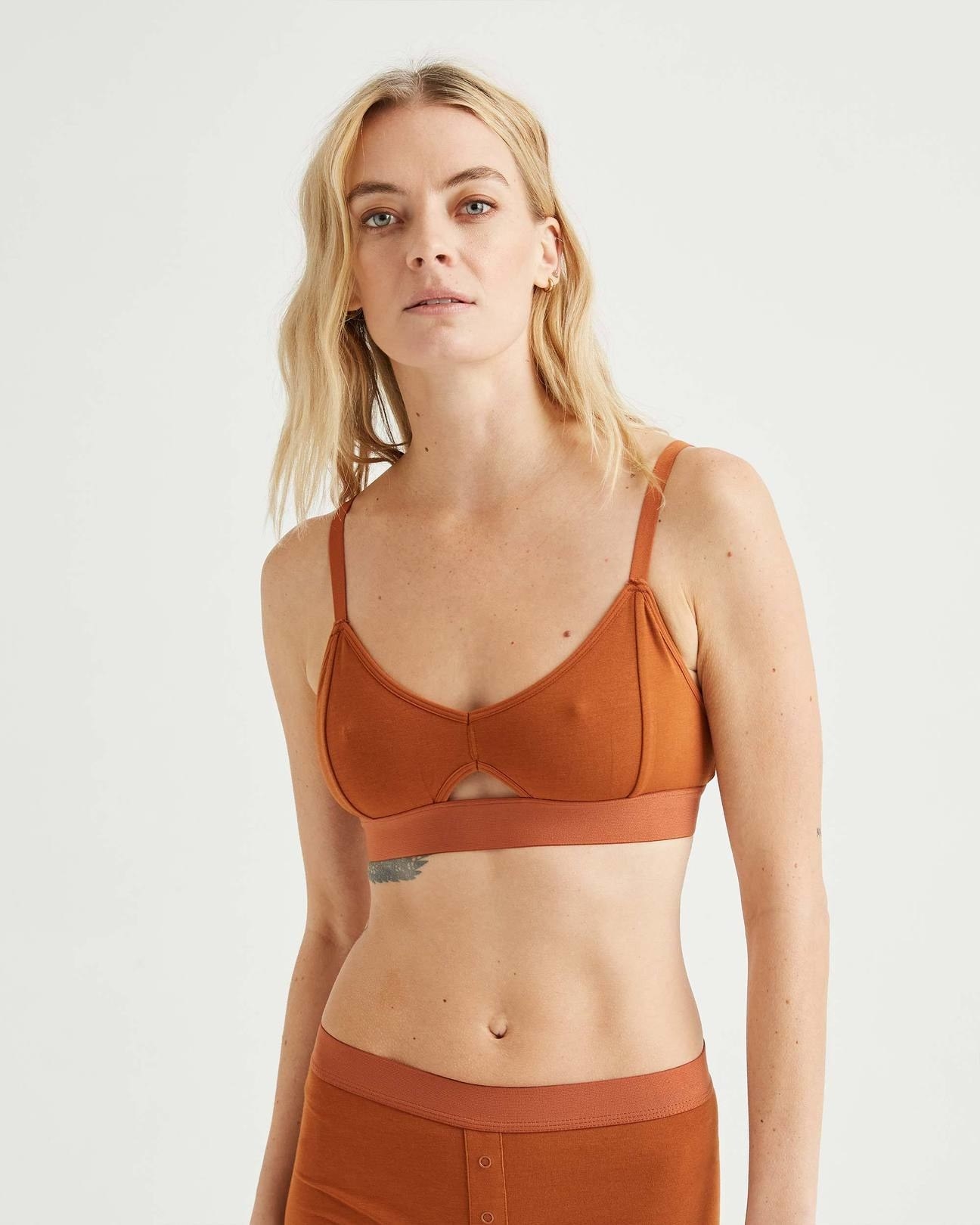 model wearing the bralette in burnt orange
