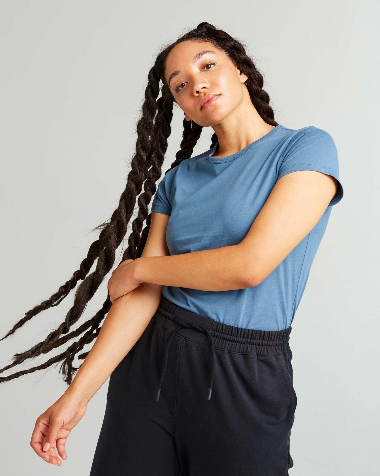 model wearing the shirt in blue with black pants